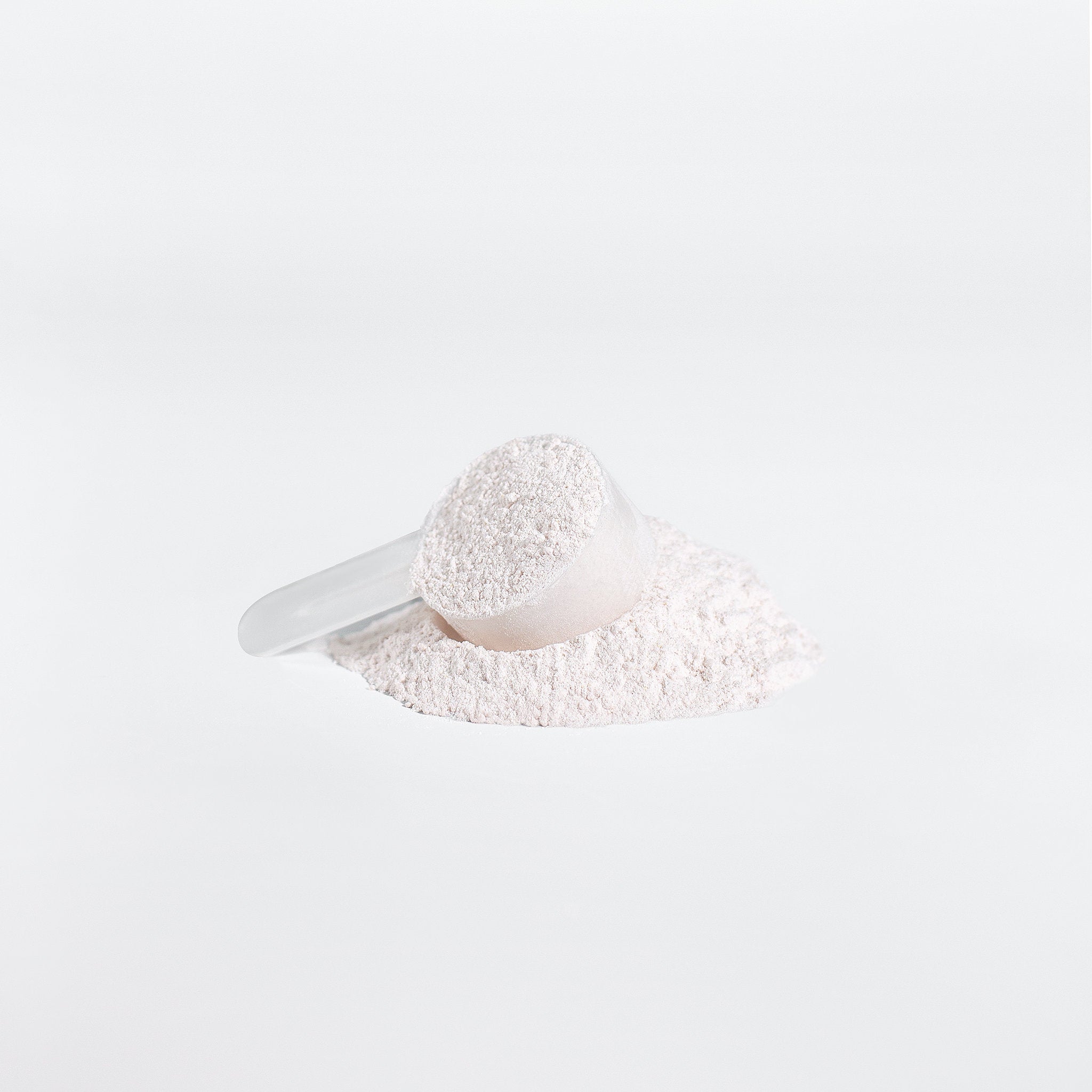 White scoop with powder on a white background