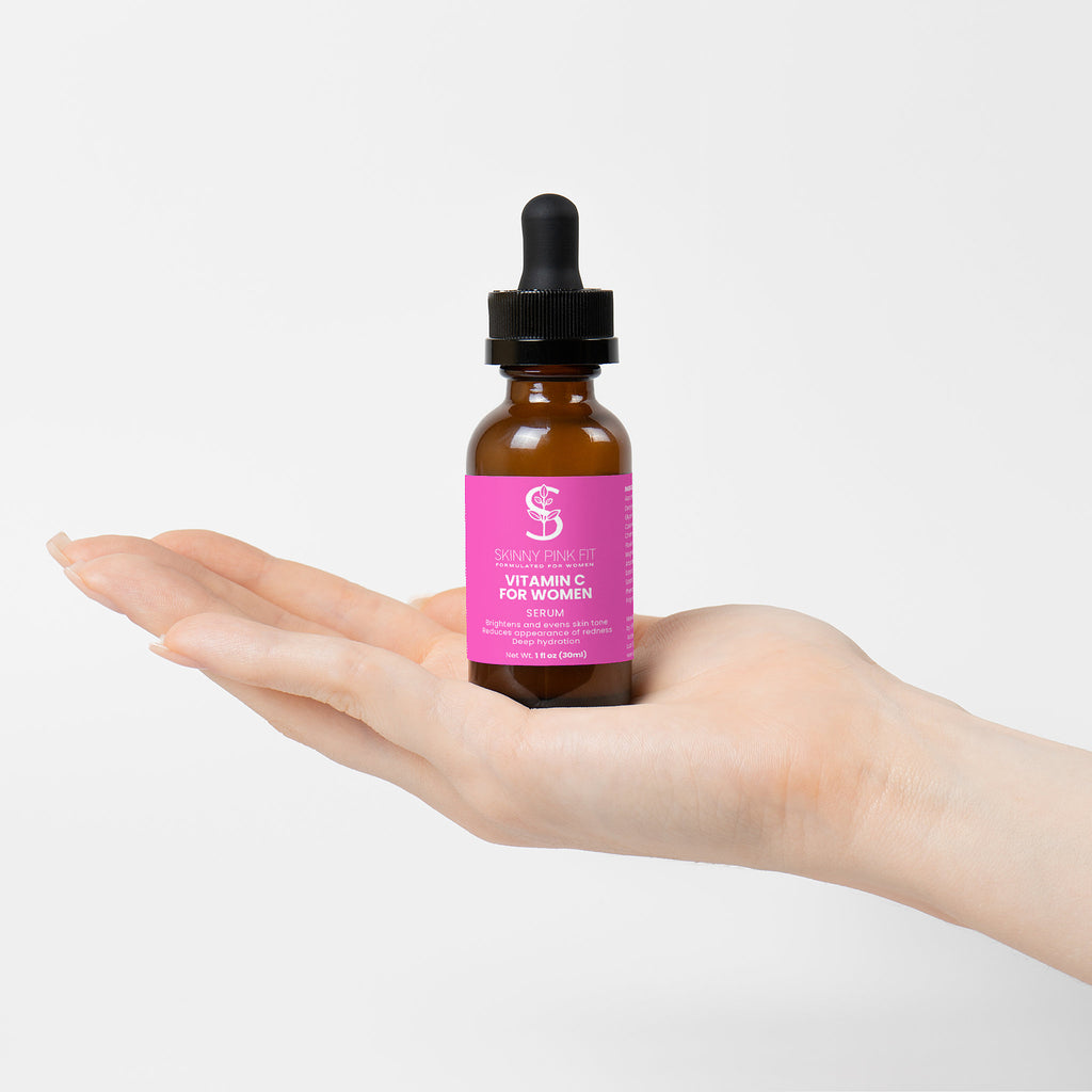 Hand holding a bottle of 'S' cream with a pink label on a white background, Skinny Pink Fit